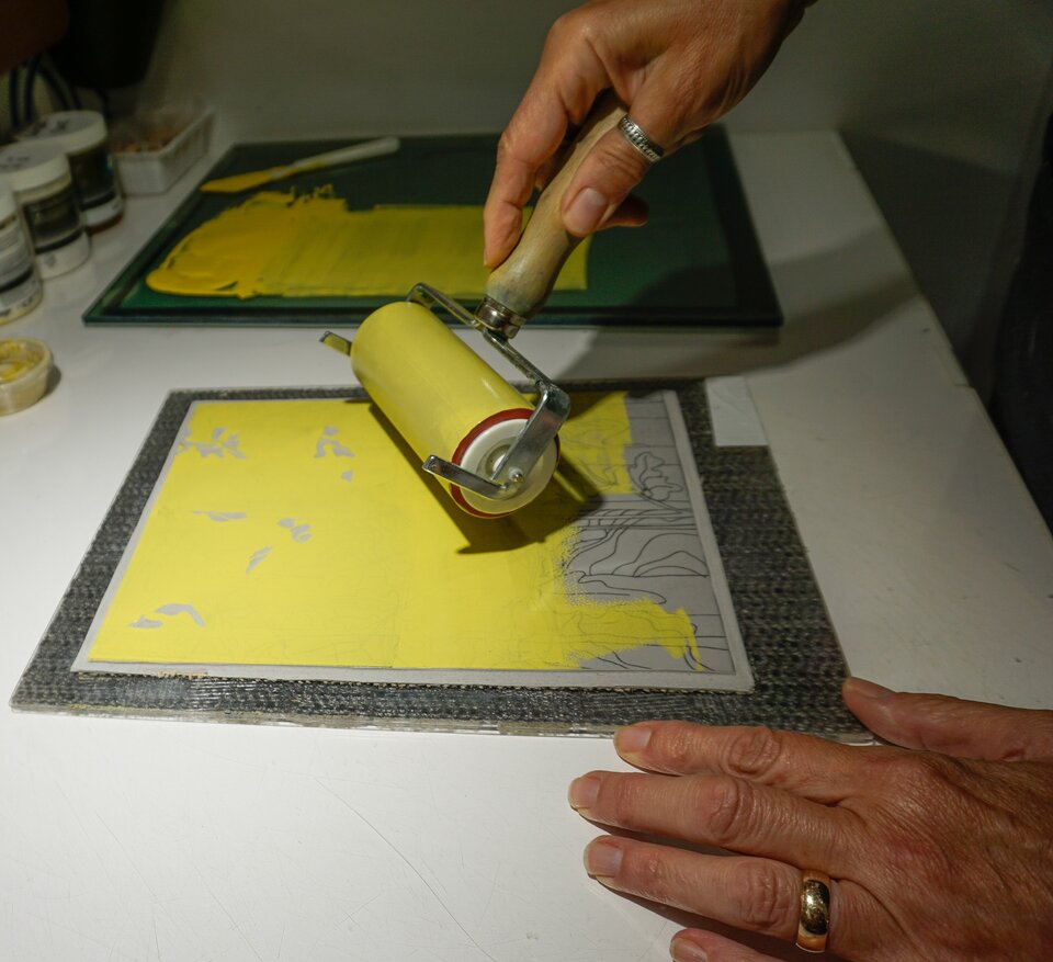 Rolling ink onto the linoleum block